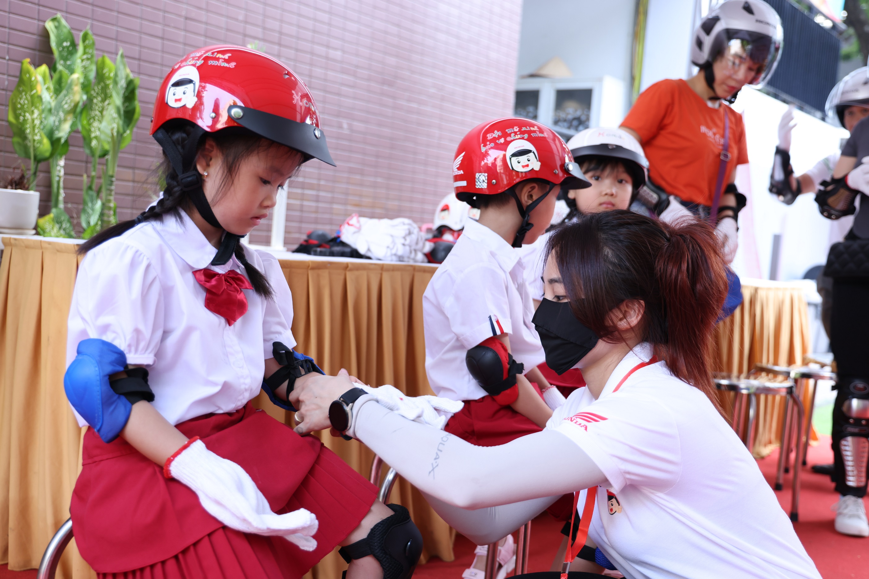 Honda Việt Nam tổng kết Trao tặng mũ bảo hiểm cho học sinh lớp Một trên toàn quốc năm học 2023 – 2024 10-cac-em-hoc-sinh-duoc-trang-bi-an-toan-truoc-khi-thuc-hanh-tu-the-ngoi-sau-xe-may-an-toan.JPG